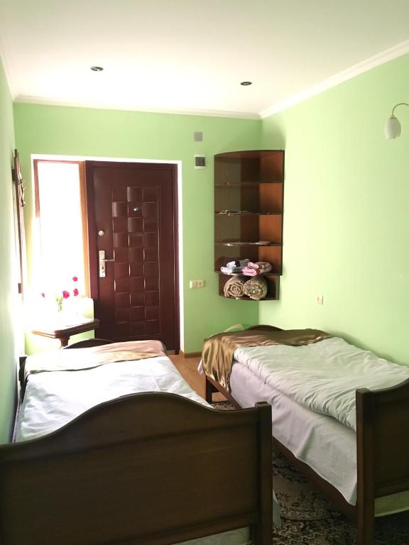Postel nebo postele na pokoji v ubytování Dilbo House