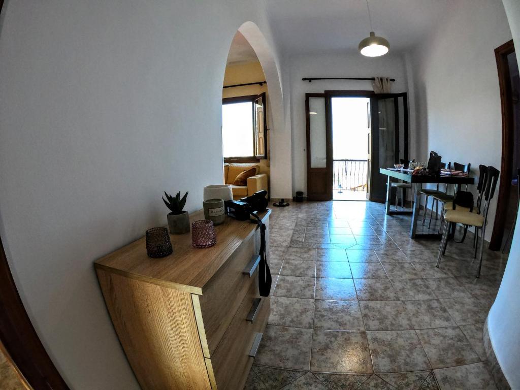 a living room with a counter and a dining room at Korali in Symi