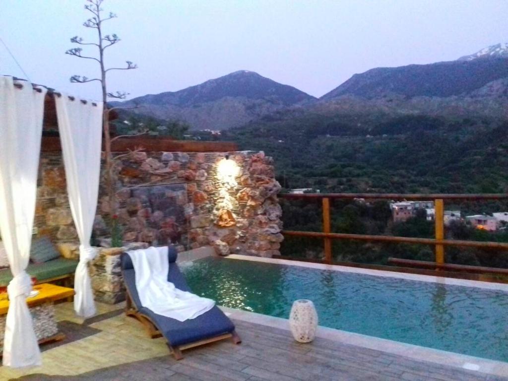 a swimming pool with a view of the mountains at Villa Aeolus with private overflow, endless, heated pool in Prinés