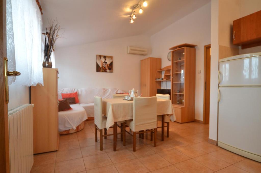 a kitchen and dining room with a table and a refrigerator at Big Dream 2 in Rovinj