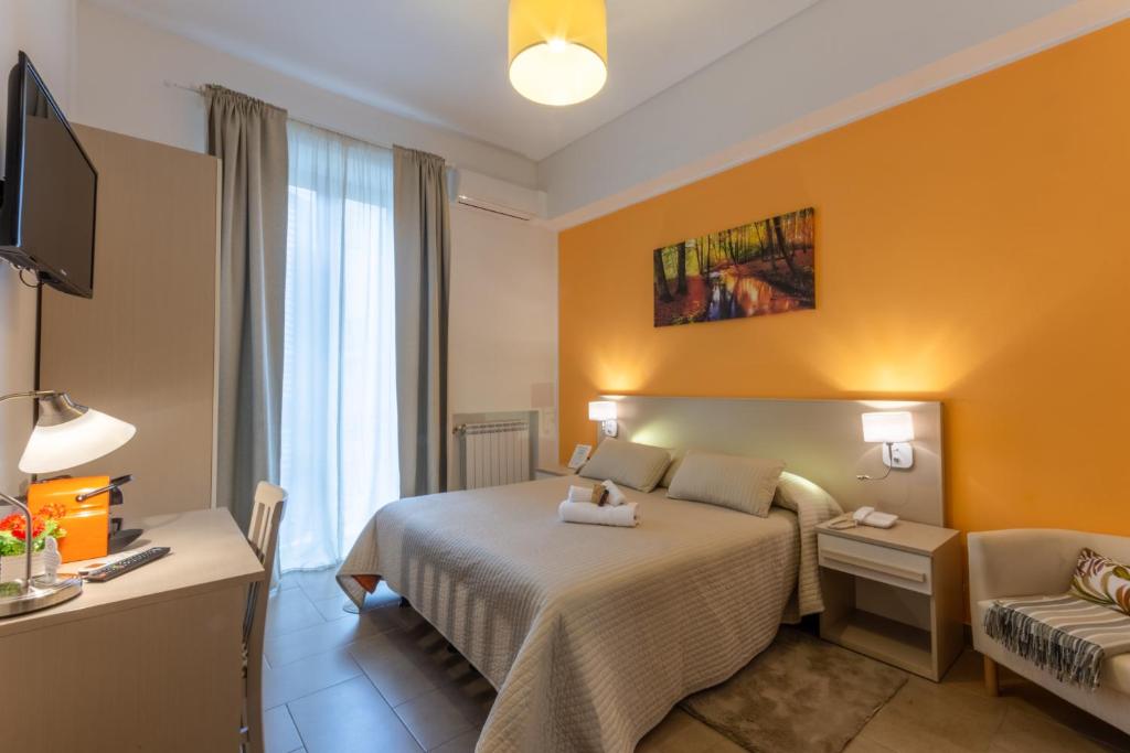 ein Hotelzimmer mit einem Bett und einem Sofa in der Unterkunft B&B Cairoli in Messina