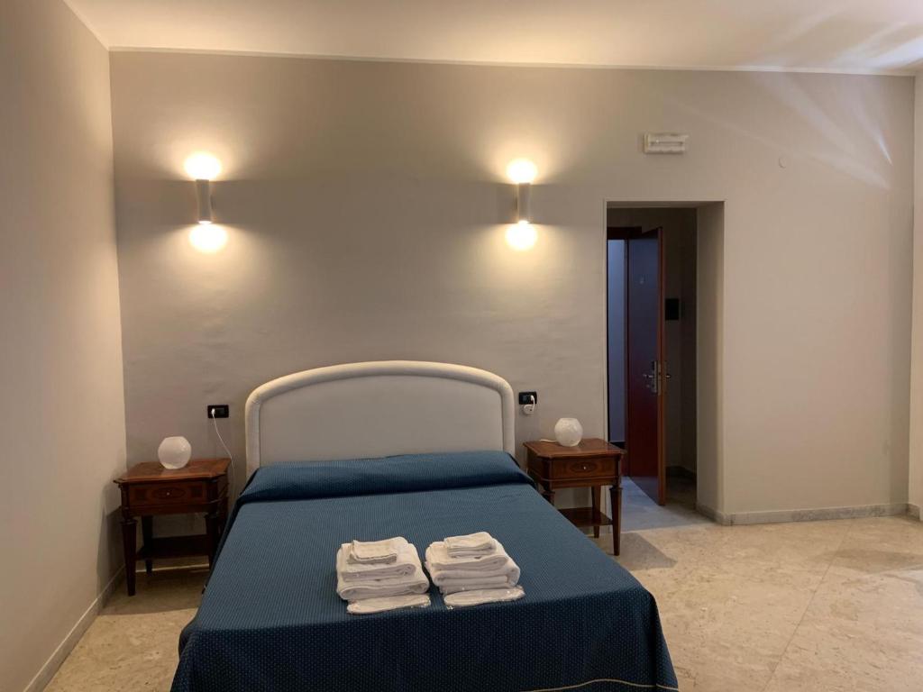 Postel nebo postele na pokoji v ubytování Hotel Lungomare