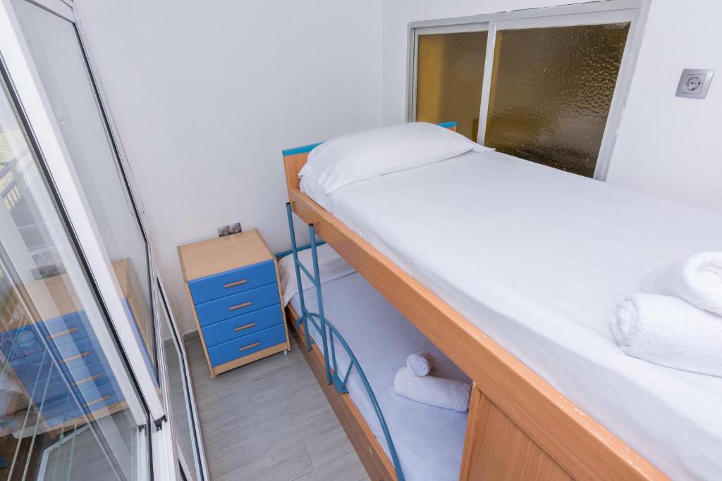 Posteľ alebo postele v izbe v ubytovaní HomeHolidaysRentals Vall III