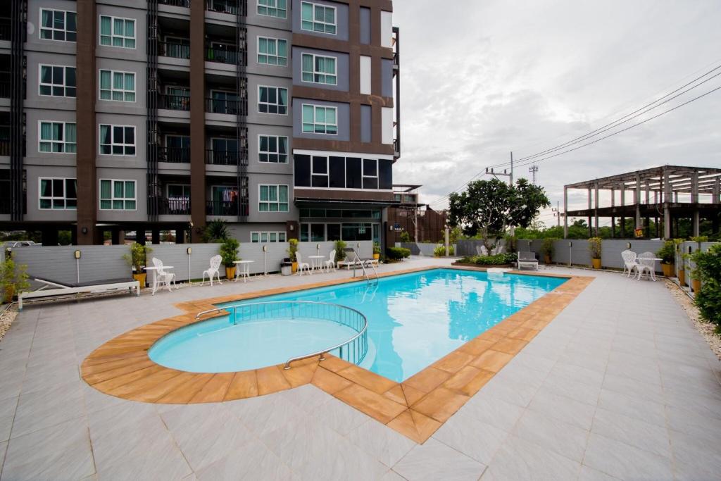 a swimming pool in front of a building at Aonang Ocean View Studio ( The Sea Condo ) in Ao Nang Beach