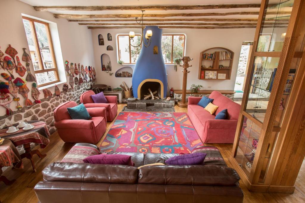 a living room with a couch and a fireplace at SAUCE Hotel Boutique in Ollantaytambo