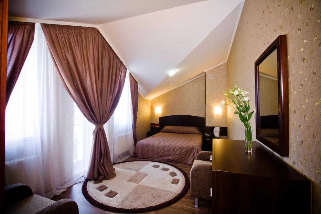 a hotel room with a bed and a mirror at City Club in Kharkiv
