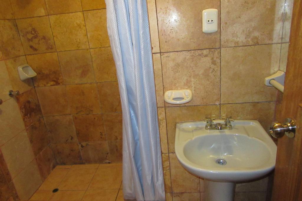 a bathroom with a sink and a shower at Hospedaje Kamila in Cusco