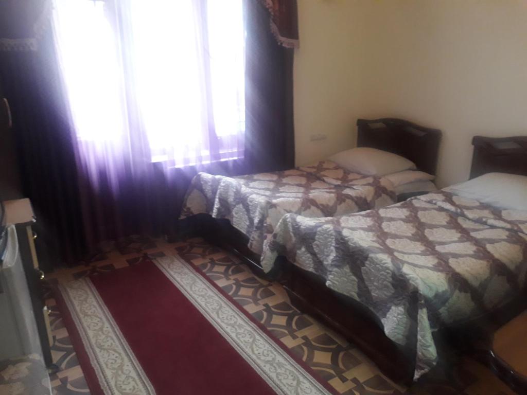 Postel nebo postele na pokoji v ubytování Hotel Noy