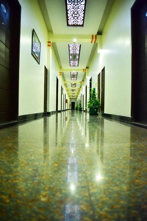an empty hallway of a building with ailed floor at Hotel Blue Sapphire in Dar es Salaam