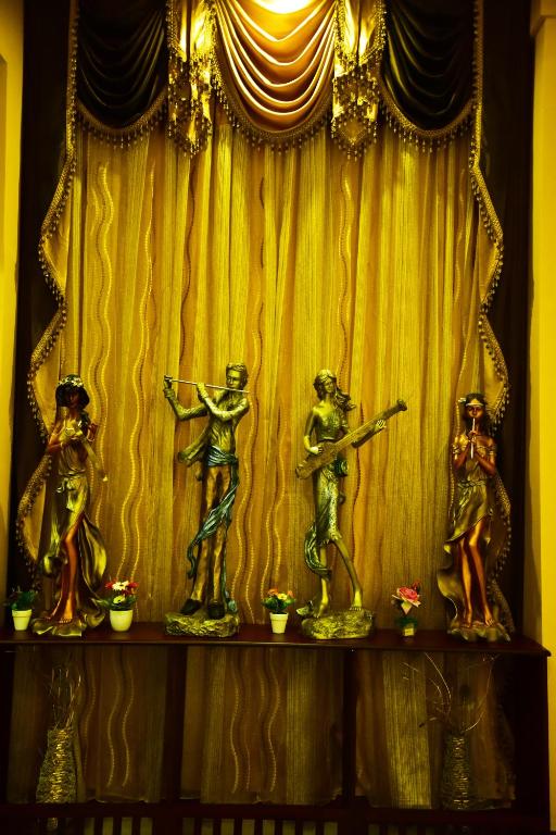 a group of figurines on a shelf in front of a curtain at Hotel Blue Sapphire in Dar es Salaam