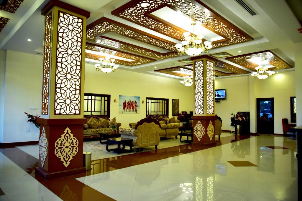 a living room with a lobby with couches and chairs at Hotel Blue Sapphire in Dar es Salaam