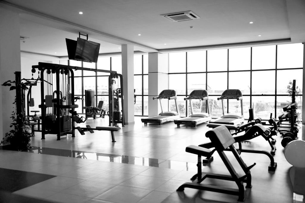 a gym with treadmills and machines in a building at Hotel Blue Sapphire in Dar es Salaam