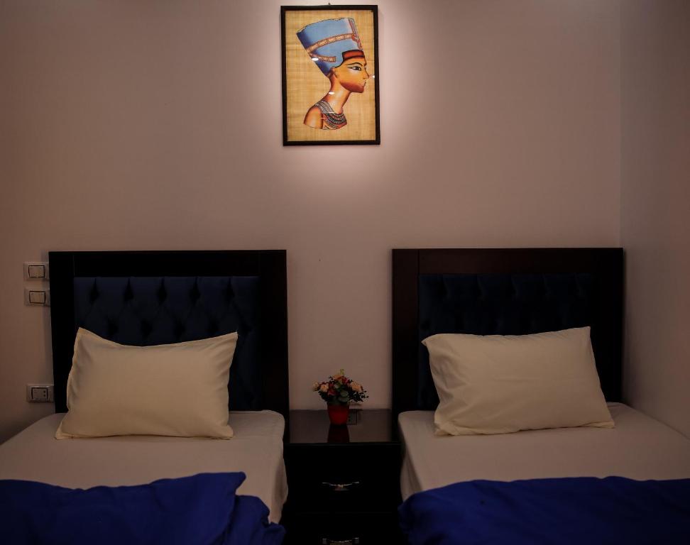 Letto o letti in una camera di Queen Pyramids View Inn