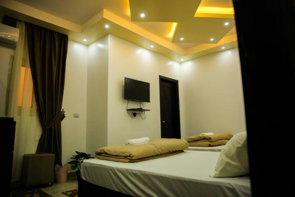 Letto o letti in una camera di Queen Pyramids View Inn