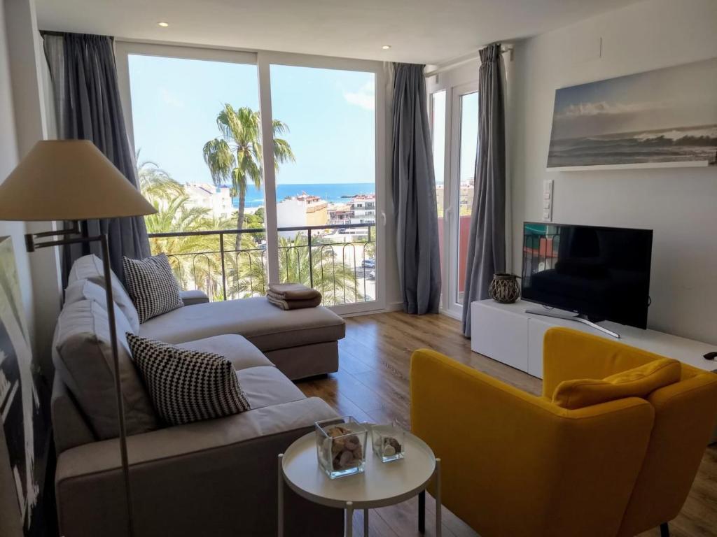 a living room with a view of the ocean at Larala 01- Nuevo apartamento en el Arenal con vistas al mar in Jávea