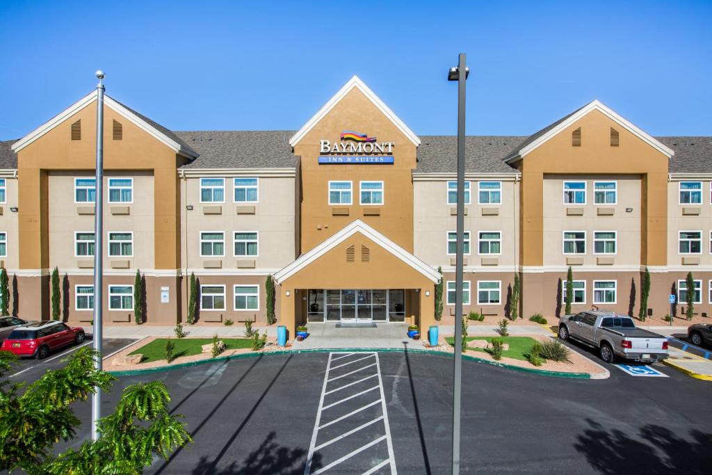 an image of a brampton hotel with a parking lot at Baymont by Wyndham Albuquerque Airport in Albuquerque