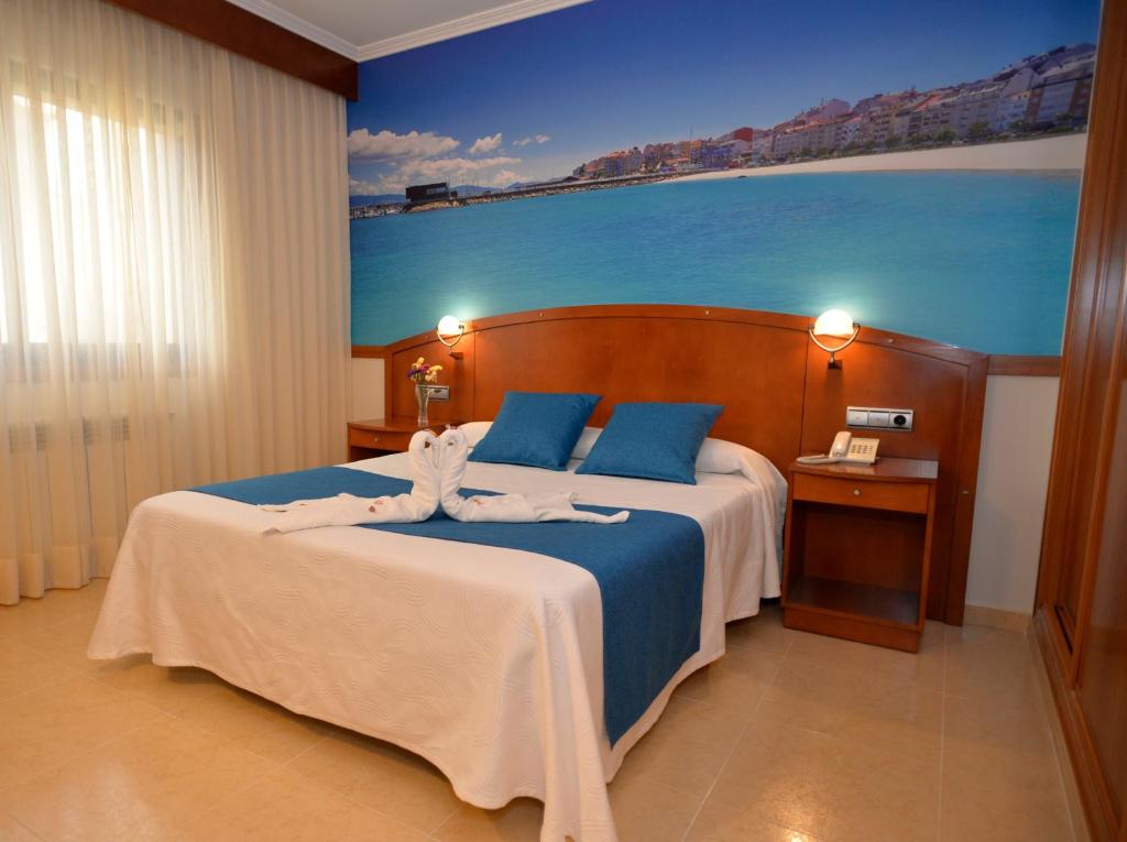 Postel nebo postele na pokoji v ubytování Hotel Portonovo