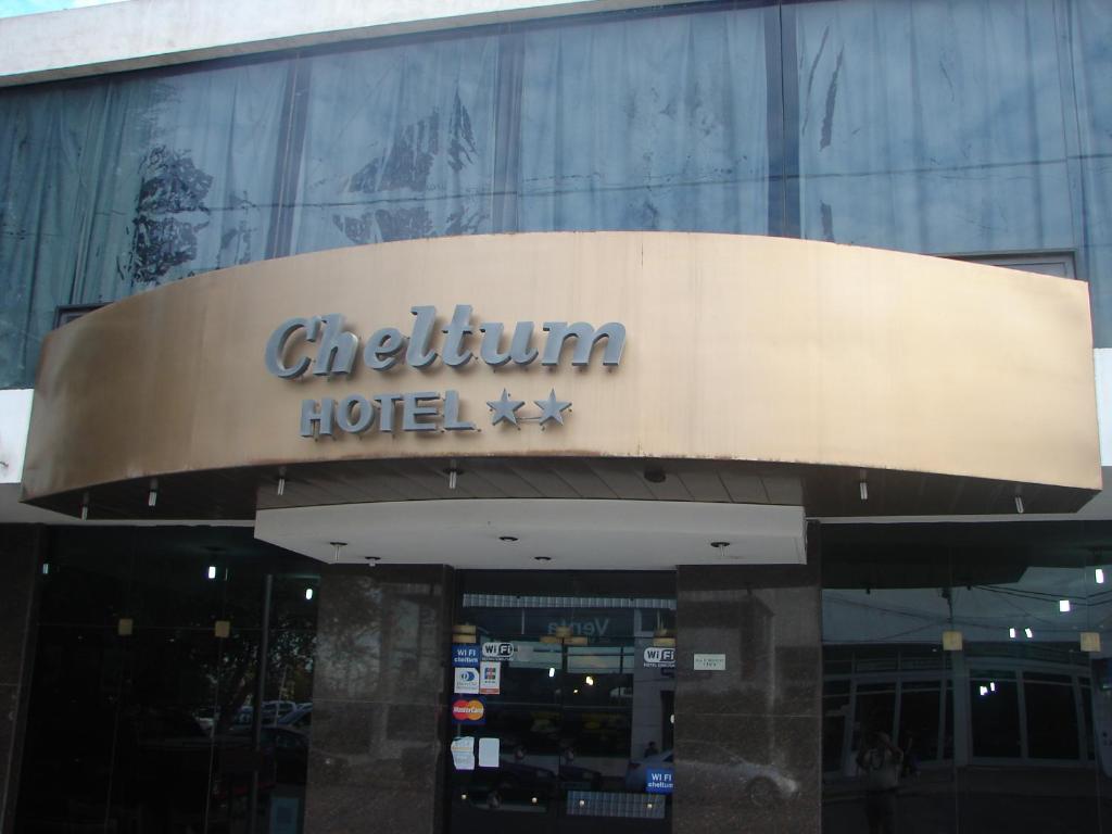 a sign for a hotel in front of a building at Cheltum Hotel in Trelew