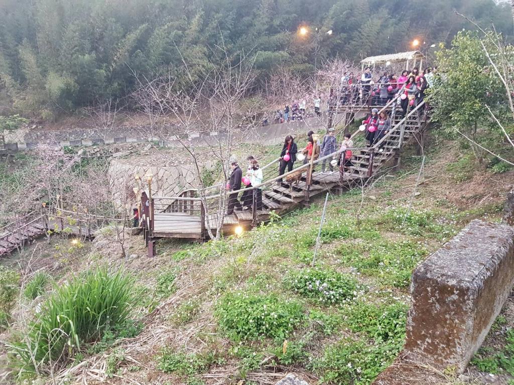 a group of people on a bridge over a hill at Ming Yang B&amp;B in Fenqihu