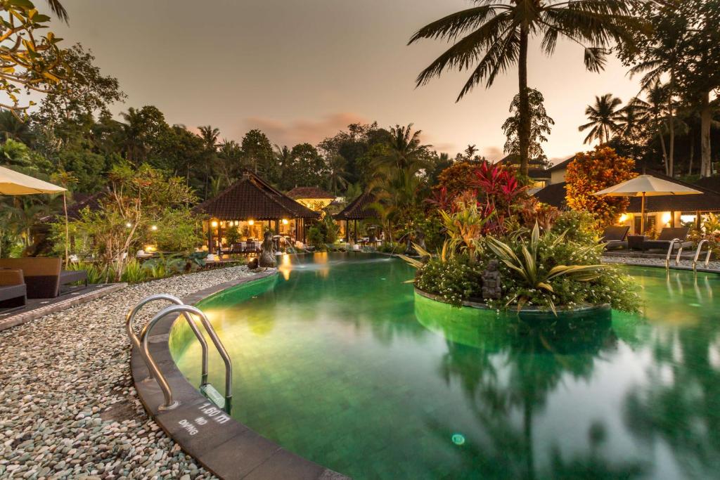 a swimming pool at a resort at night at Villa Taman di Blayu by Nagisa Bali in Tabanan
