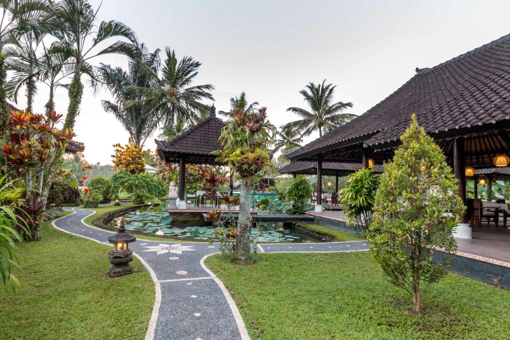 a view of a resort with a garden and a pond at Villa Taman di Blayu by Nagisa Bali in Tabanan