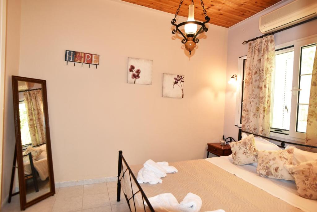 a bedroom with a bed and a window and a mirror at BETTY'S HOUSE in Pythagoreio