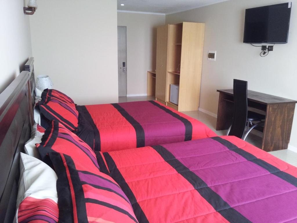 Postel nebo postele na pokoji v ubytování Hotel Astore Suites