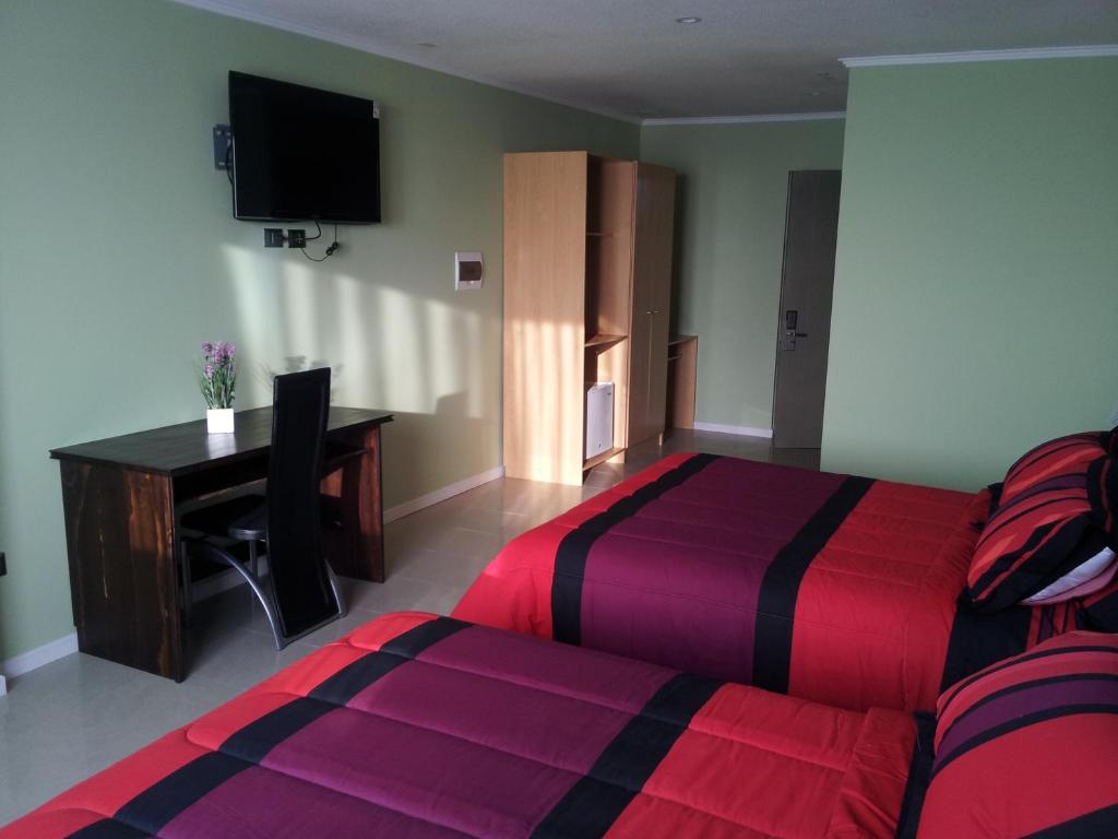 A bed or beds in a room at Hotel Astore Suites