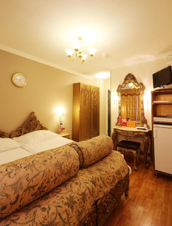 Postel nebo postele na pokoji v ubytování Mango Hotel