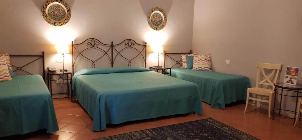Postel nebo postele na pokoji v ubytování Etna Hotel
