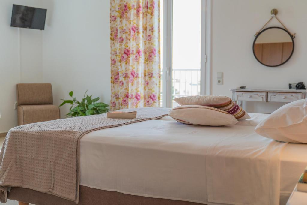 a bed with two pillows on it in a room at Kassiani Studios in Plakias
