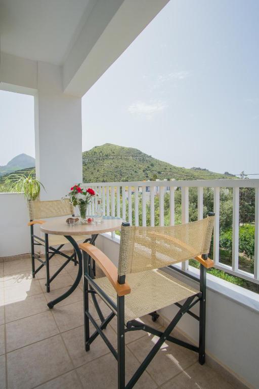 a patio with a table and chairs on a balcony at Kassiani Studios in Plakias