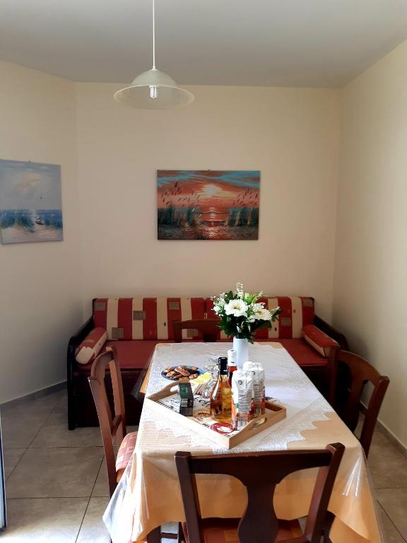 a dining room with a table and a couch at Vrokastro Apartments in Istro
