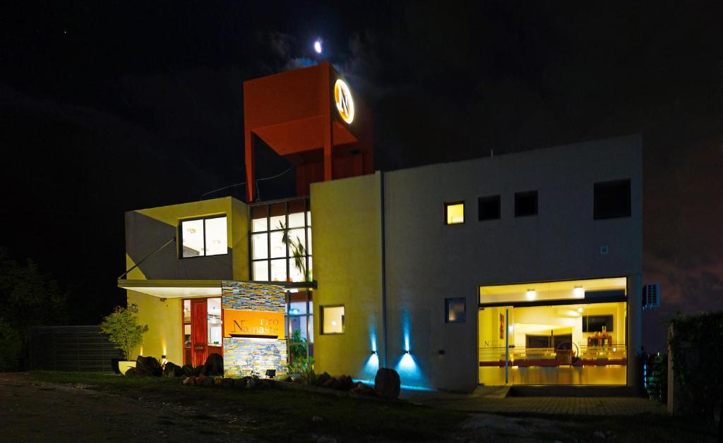 a building with a clock on top of it at night at Complejo Namaste in San Antonio de Arredondo