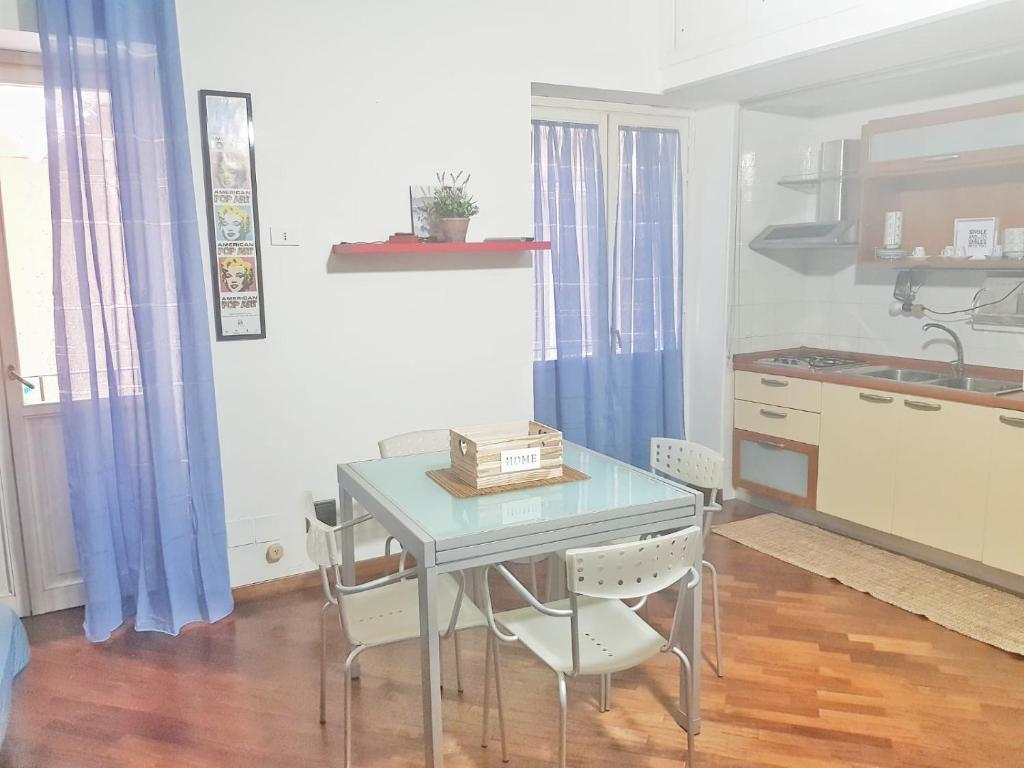 eine Küche mit einem Tisch mit Stühlen und einem Waschbecken in der Unterkunft Oly99 in Palermo