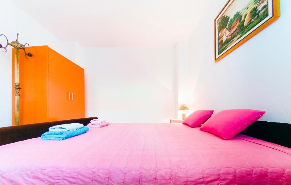 Postel nebo postele na pokoji v ubytování Apartmani Slavica