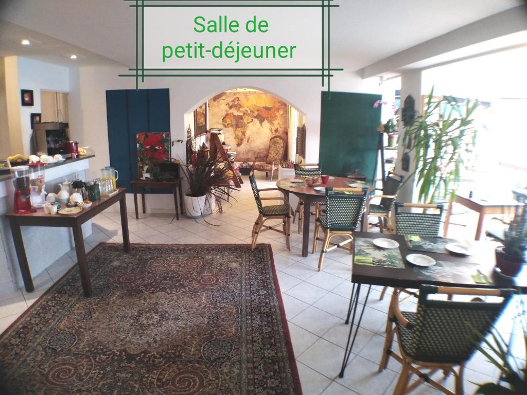 a room with tables and chairs and a sale sign at Le vent des globes in Les Sables-d'Olonne