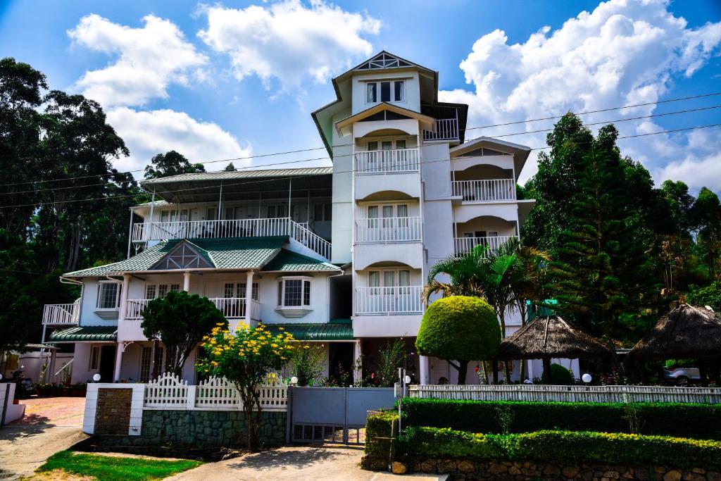 un gran edificio blanco con torreta en Lakezone Holiday Resort, en Chinnakanal