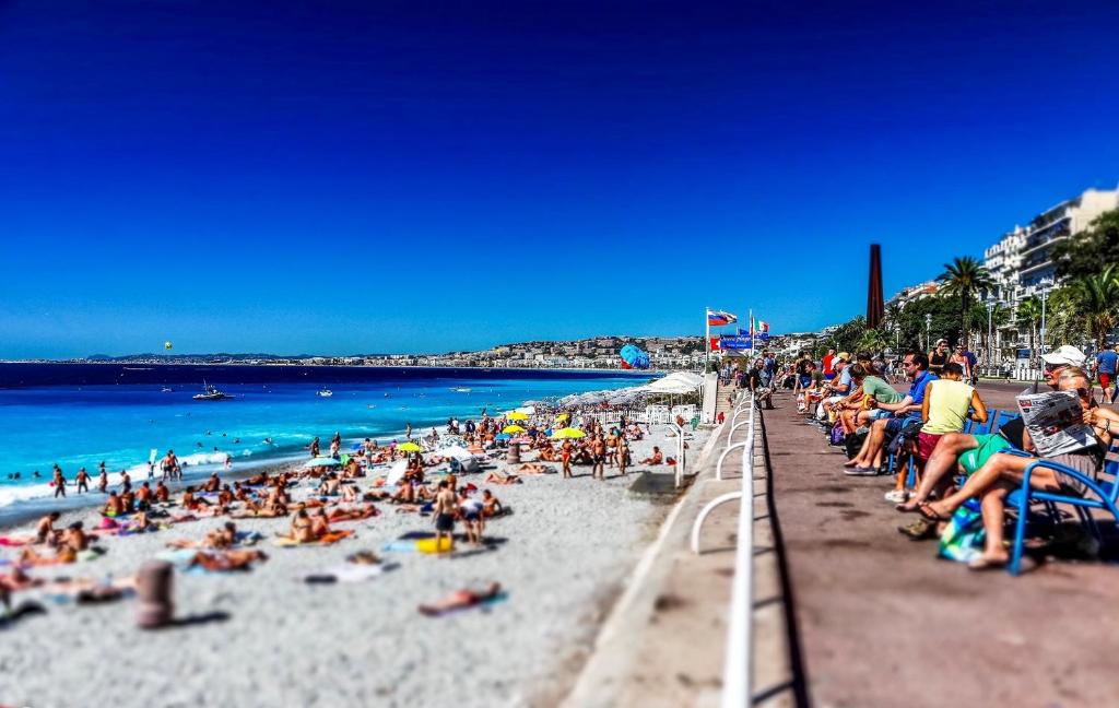 Une foule assise sur une plage dans l'établissement Palais Massena - Easy Home Booking, à Nice
