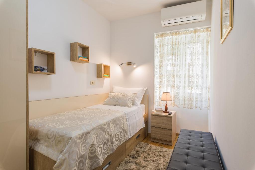 Posteľ alebo postele v izbe v ubytovaní Apartman Grgur