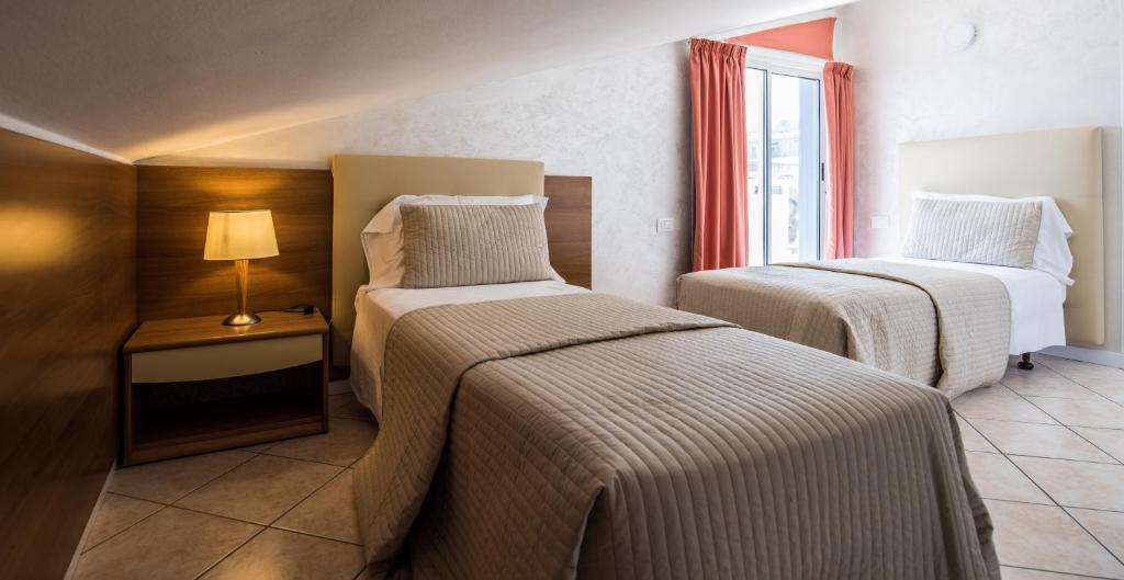 Postel nebo postele na pokoji v ubytování Hotel Touring