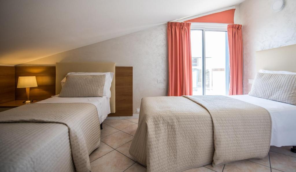 Postel nebo postele na pokoji v ubytování Hotel Touring
