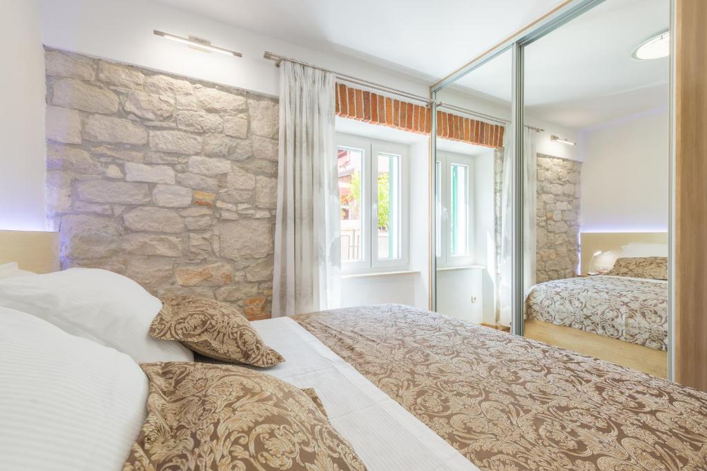 Posteľ alebo postele v izbe v ubytovaní Apartman Grgur