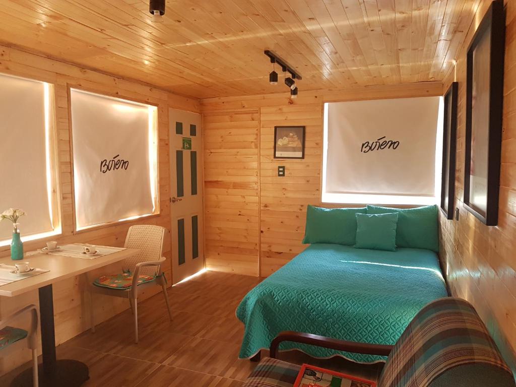 Postel nebo postele na pokoji v ubytování Cabañas Yukatan Lago de Tota