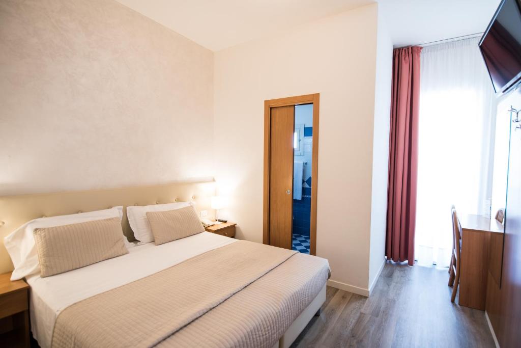 Postel nebo postele na pokoji v ubytování Hotel Touring