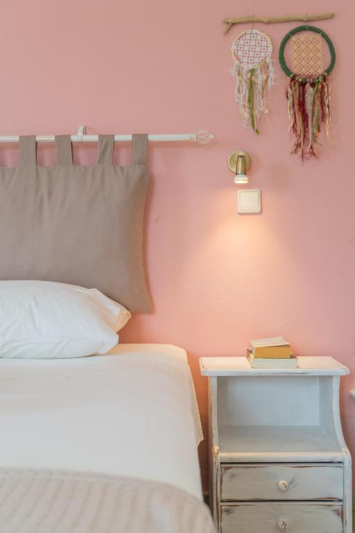 a bedroom with a bed and a nightstand next to a bed and a basketball at Kassiani Studios in Plakias