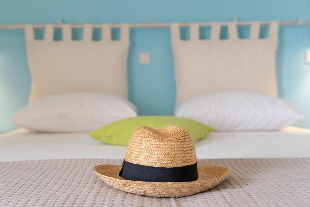 a straw hat sitting on top of a bed at Kassiani Studios in Plakias