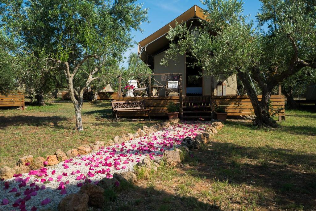 a line of flowers in front of a house at Agrikies Country Retreat in Marathopoli