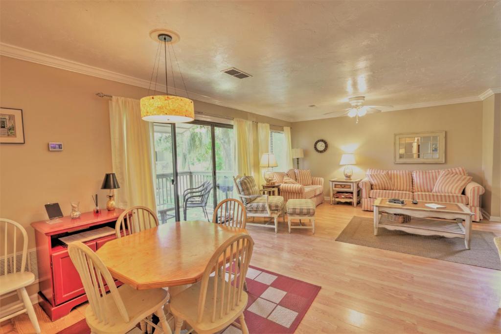 a dining room and living room with a table and chairs at 125 Cordillo Parkway in Hilton Head Island