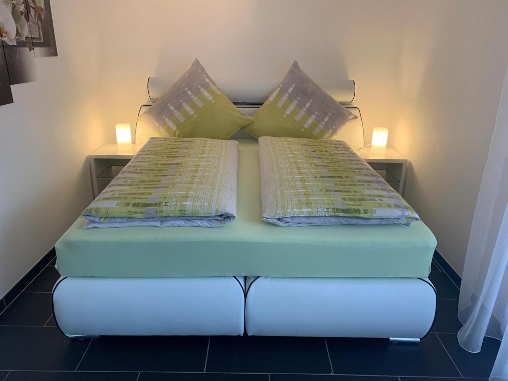 a bed in a room with two pillows on it at Orchideenweg 2b, Henstedt-Ulzburg in Henstedt-Ulzburg